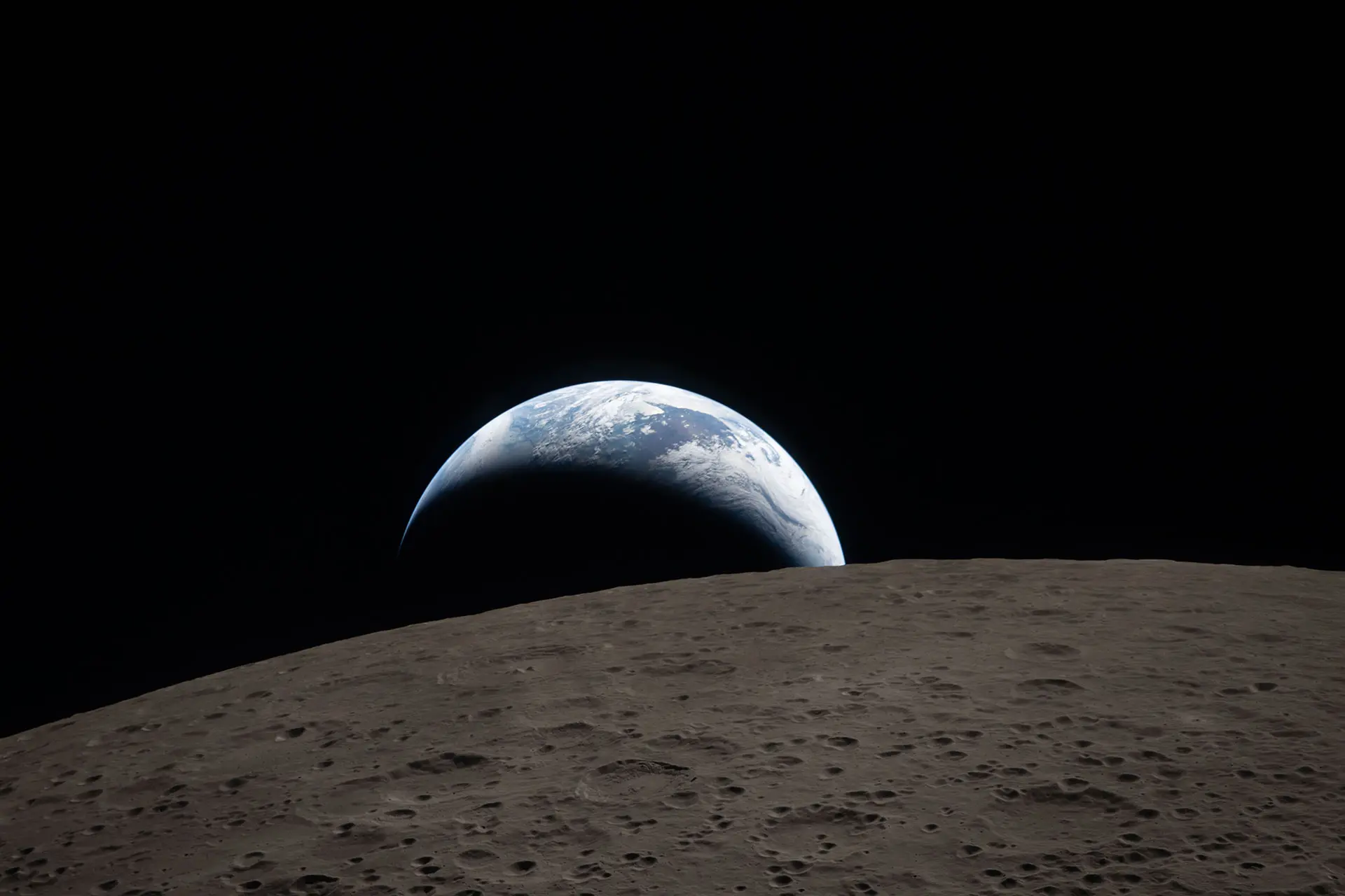 A muted blue Earth with bright white clouds sets behind the cratered lunar surface
